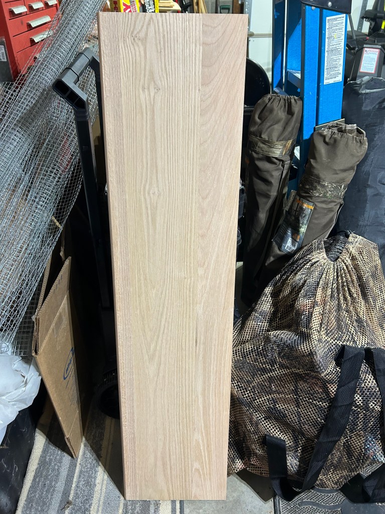 A picture of a 4ft stair tread propped against a toolbox and surrounded by misc stuff, including camping chairs, turkey decoys in a bag, and hardware cloth.