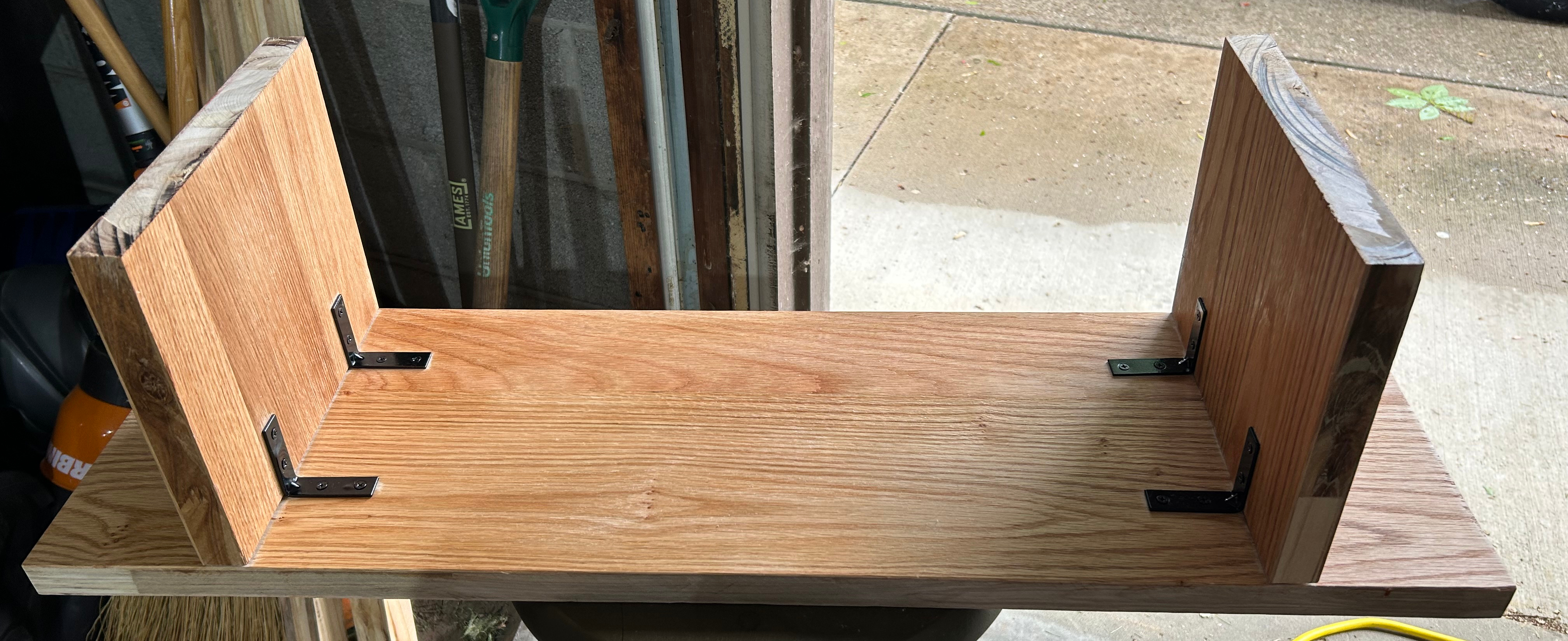 The shelf flipped upside down to show the corner braces